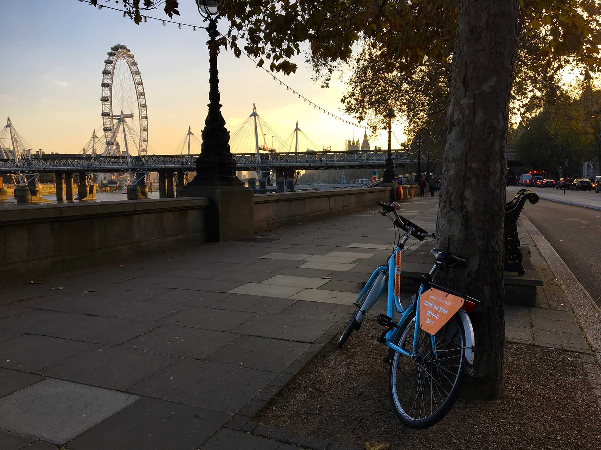 Bicycle by River Thames in London, London Eye in the background